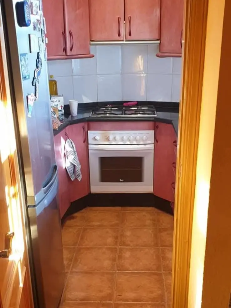 Dated kitchen in a property before renovation — before